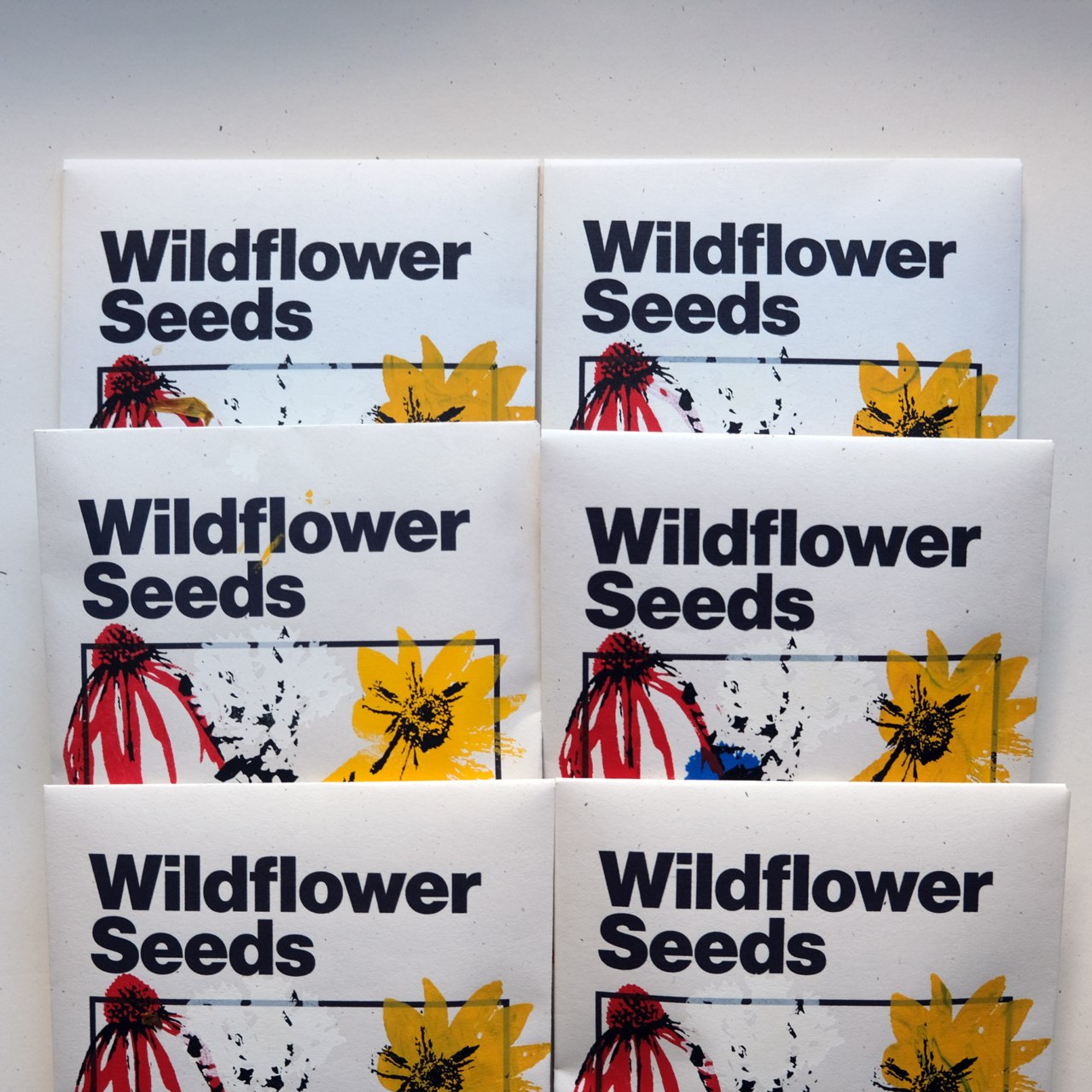 A stack of wildflower seed packets on a white background