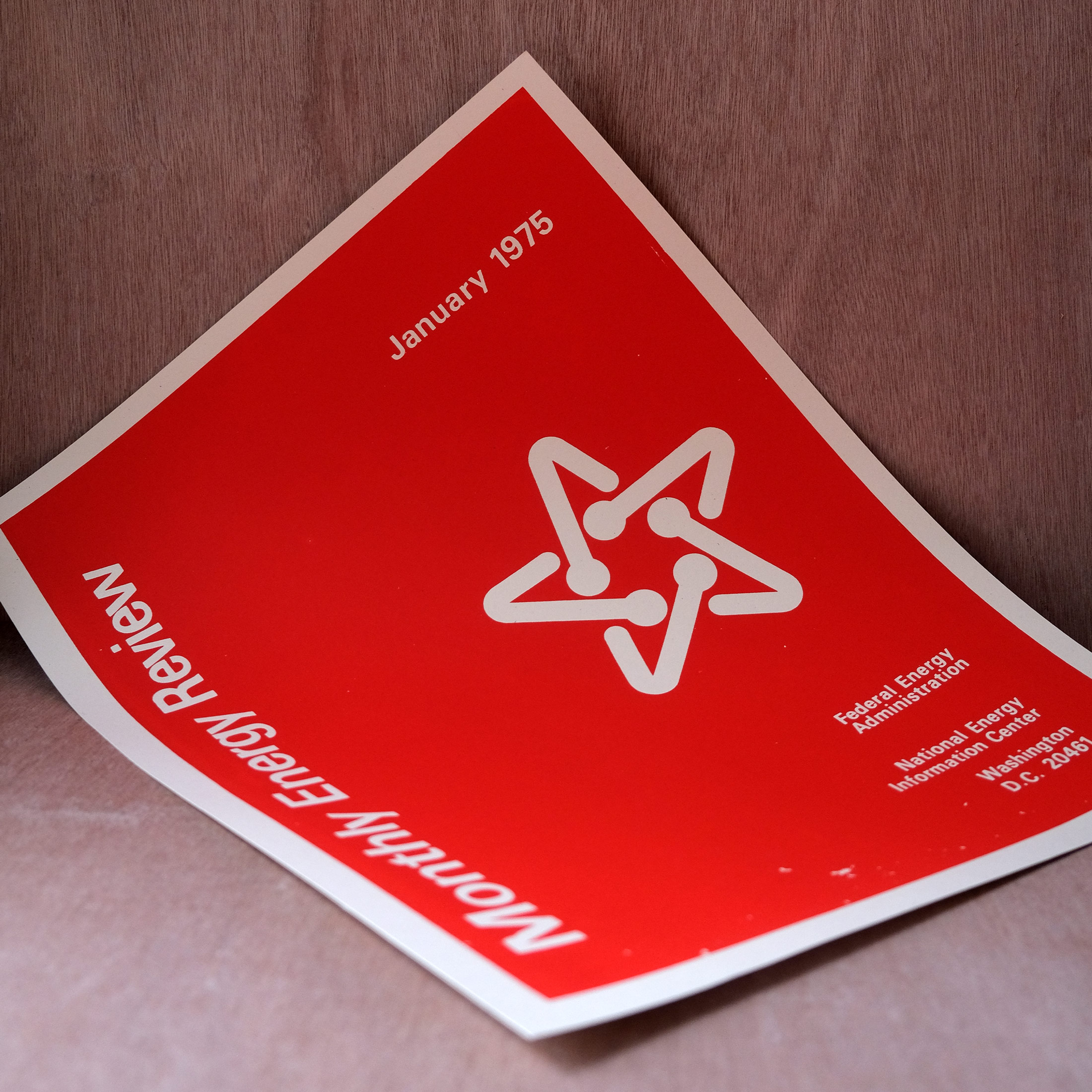 a red ink on cream paper poster of the Monthly Energy Review cover from January 1975